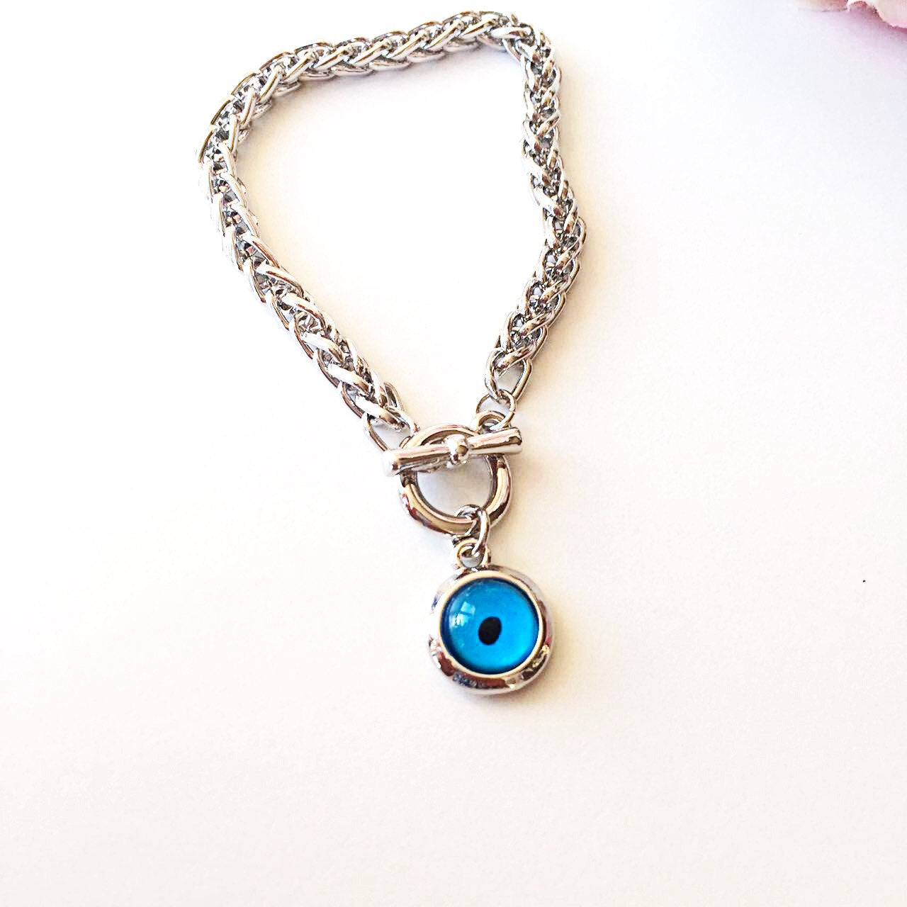 A handmade Blue Evil Eye Bracelet featuring a silver chain and a striking blue evil eye charm, symbolizing protection and good fortune.