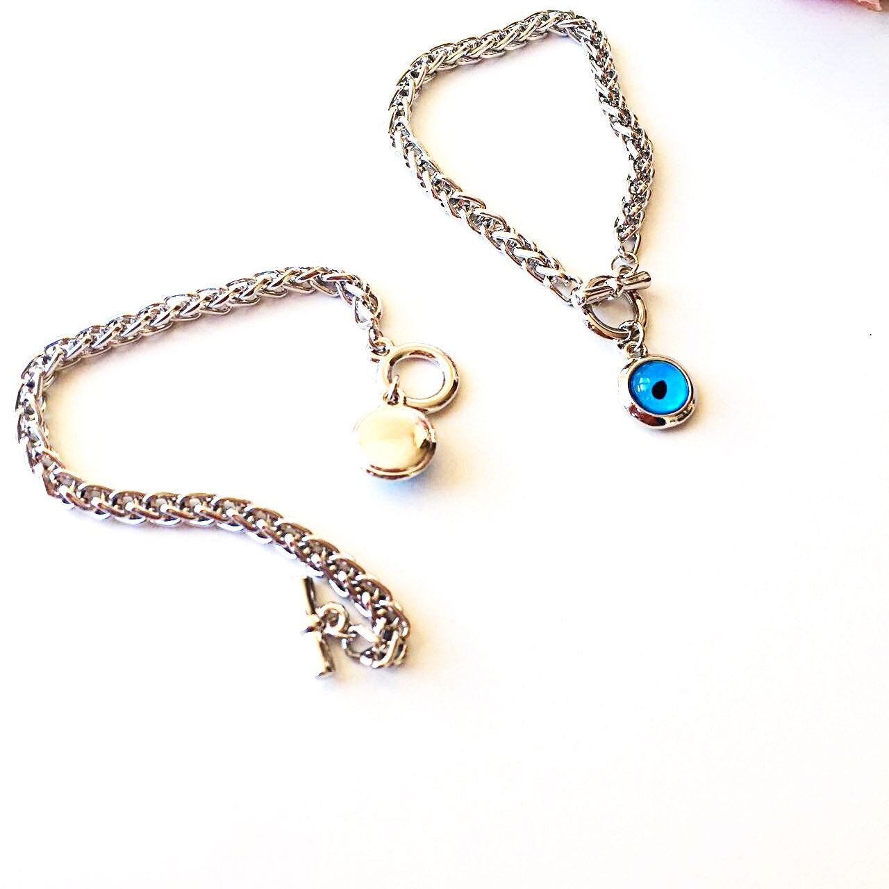 A handmade Blue Evil Eye Bracelet featuring a silver chain and a striking blue evil eye charm, symbolizing protection and good fortune.