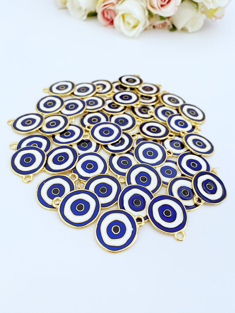 A beautiful blue evil eye charm made of brass, featuring gold plating, measuring 20mm, perfect for jewelry making.