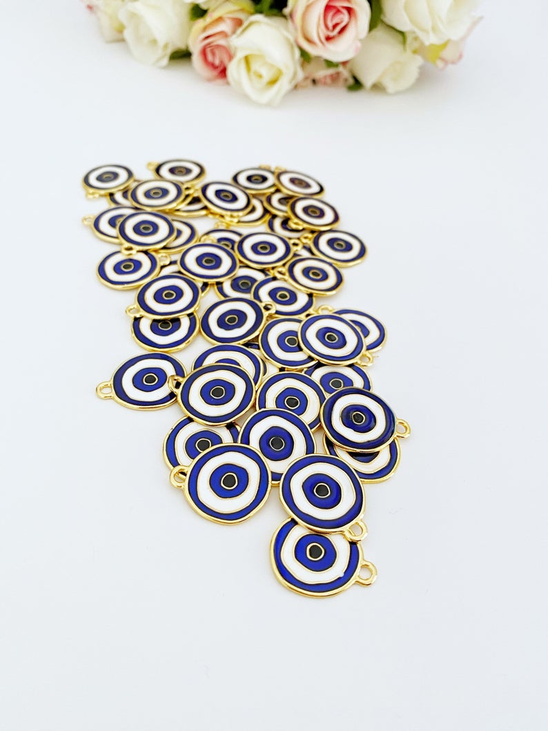 A beautiful blue evil eye charm made of brass, featuring gold plating, measuring 20mm, perfect for jewelry making.