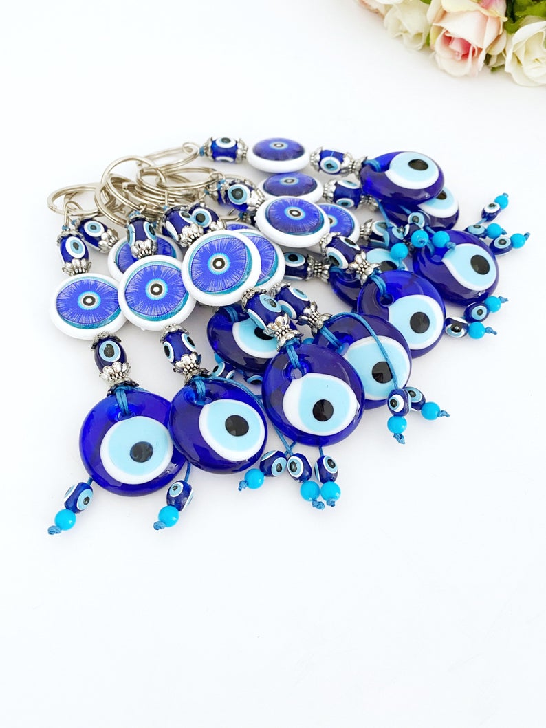 A beautiful blue evil eye keychain featuring a glass bead, symbolizing protection and good luck, attached to a silver keyring.