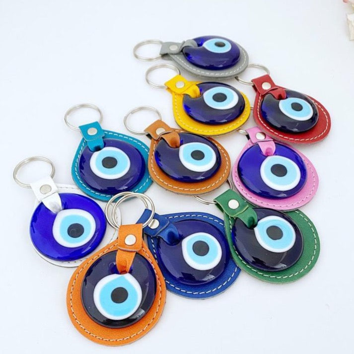 Blue Evil Eye Keychain made of faux leather with a glass evil eye charm, showcasing its stylish design and protective symbolism.