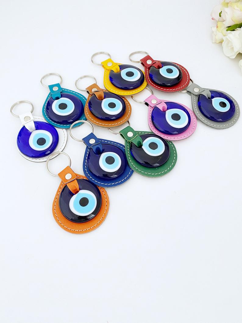 Blue Evil Eye Keychain made of faux leather with a glass evil eye charm, showcasing its stylish design and protective symbolism.