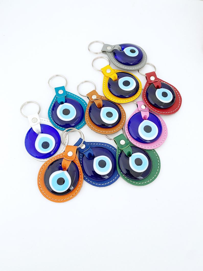 Blue Evil Eye Keychain made of faux leather with a glass evil eye charm, showcasing its stylish design and protective symbolism.