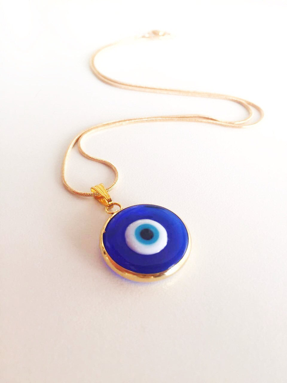 Handmade Blue Evil Eye Murano Necklace featuring dark blue glass beads and a 22K gold plated chain, symbolizing protection.