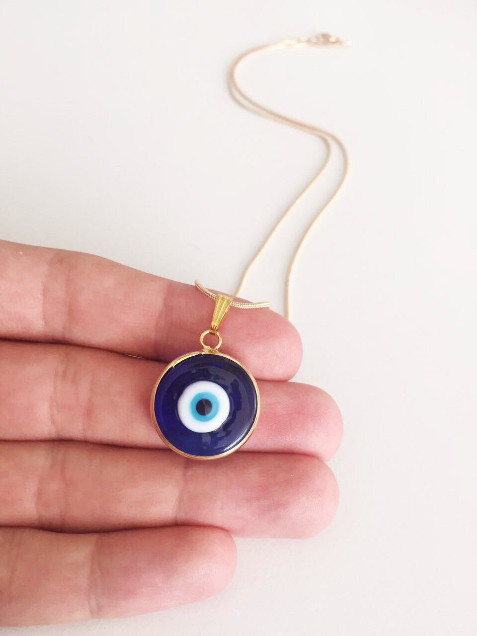 Handmade Blue Evil Eye Murano Necklace featuring dark blue glass beads and a 22K gold plated chain, symbolizing protection.