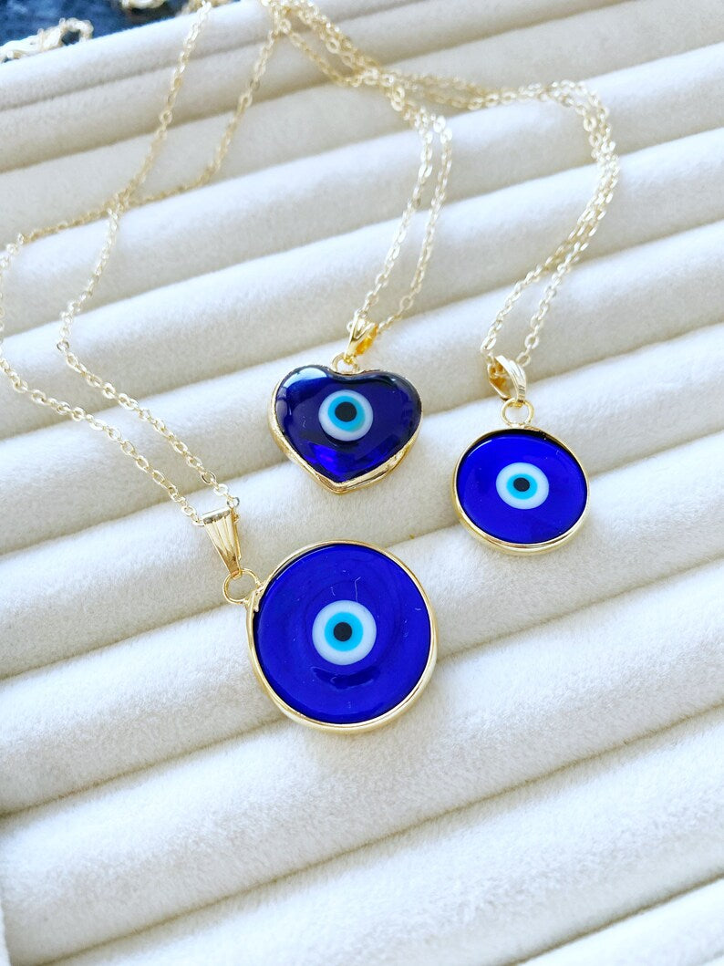 A beautiful Blue Evil Eye Necklace featuring a Murano glass bead and a gold stainless steel chain, showcasing intricate craftsmanship.