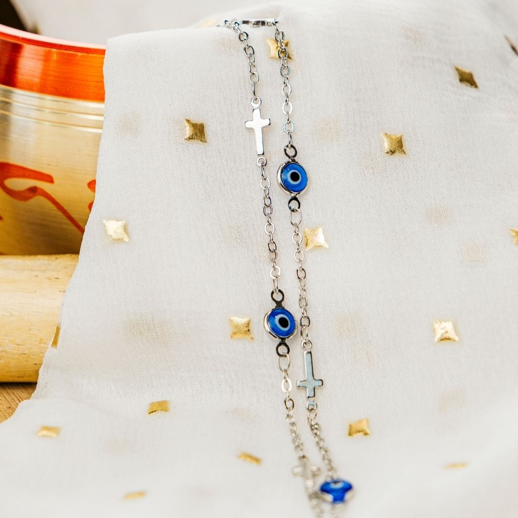 Blue Evil Eye Sideways Cross Choker featuring a dainty metal alloy chain with evil eye charms and a sideways cross design in gold and silver.