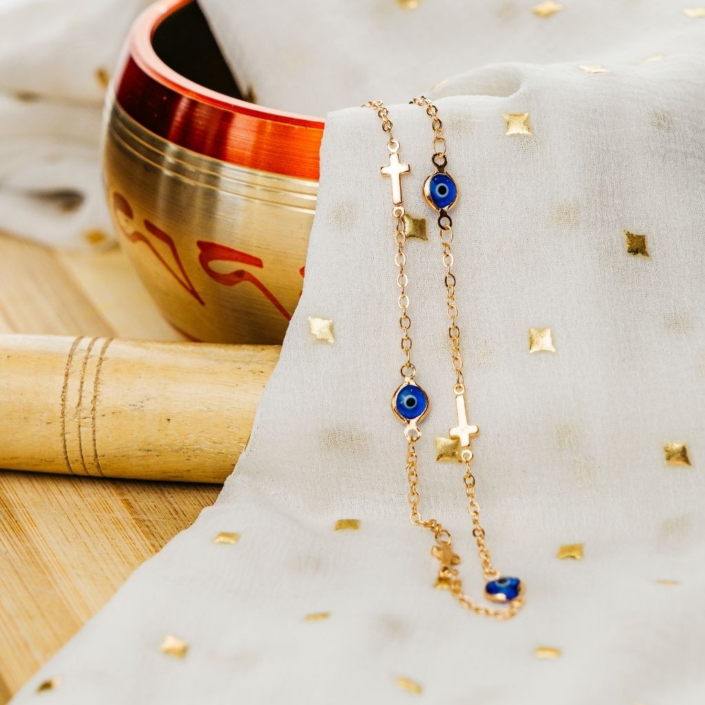 Blue Evil Eye Sideways Cross Choker featuring a dainty metal alloy chain with evil eye charms and a sideways cross design in gold and silver.