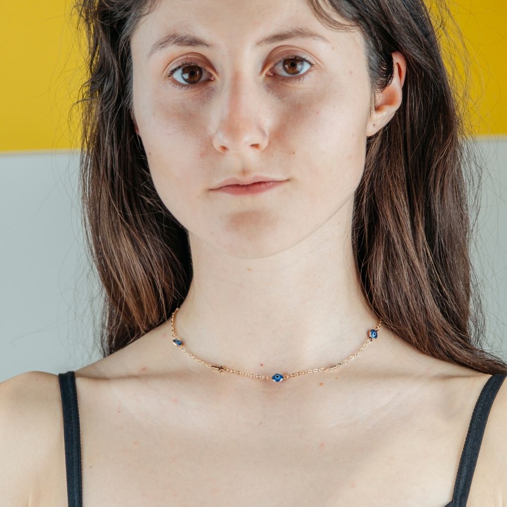 Blue Evil Eye Sideways Cross Choker featuring a dainty metal alloy chain with evil eye charms and a sideways cross design in gold and silver.