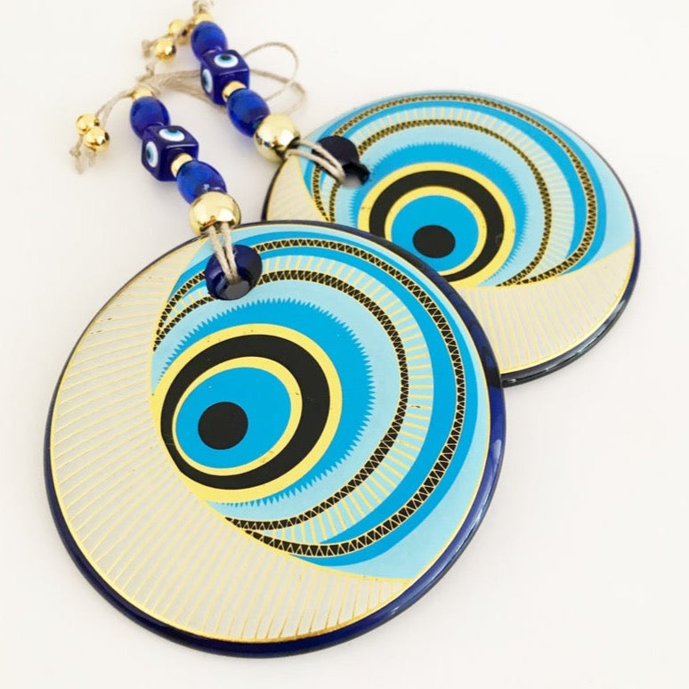 A beautiful blue evil eye wall hanging featuring intricate patterns, measuring 30cm in length with a large 13cm evil eye centerpiece.