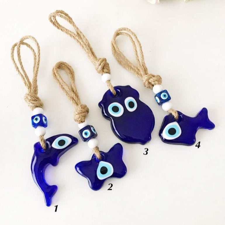 Handmade Blue Glass Evil Eye Wall Hanging featuring dolphin, butterfly, owl, and fish designs, elegantly crafted with macrame.