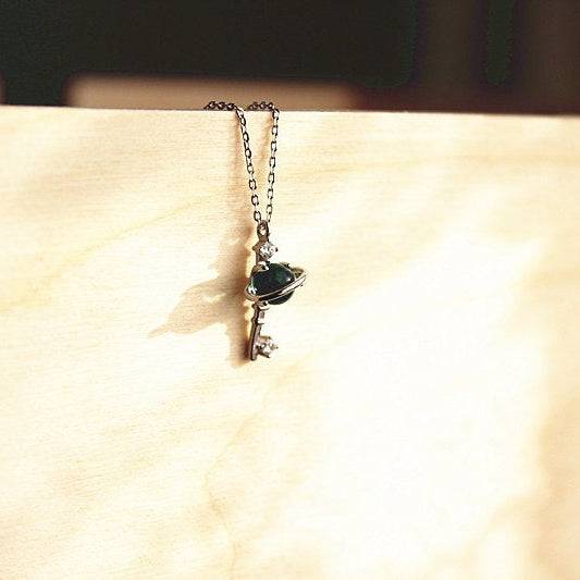Blue Planet Star Uranus Theme Key Shape Charm Necklace featuring a light blue crystal globe and sterling silver design.