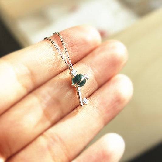Blue Planet Star Uranus Theme Key Shape Charm Necklace featuring a light blue crystal globe and sterling silver design.
