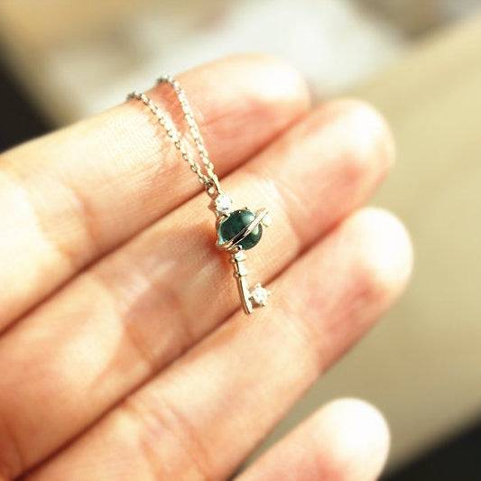 Blue Planet Star Uranus Theme Key Shape Charm Necklace featuring a light blue crystal globe and sterling silver design.