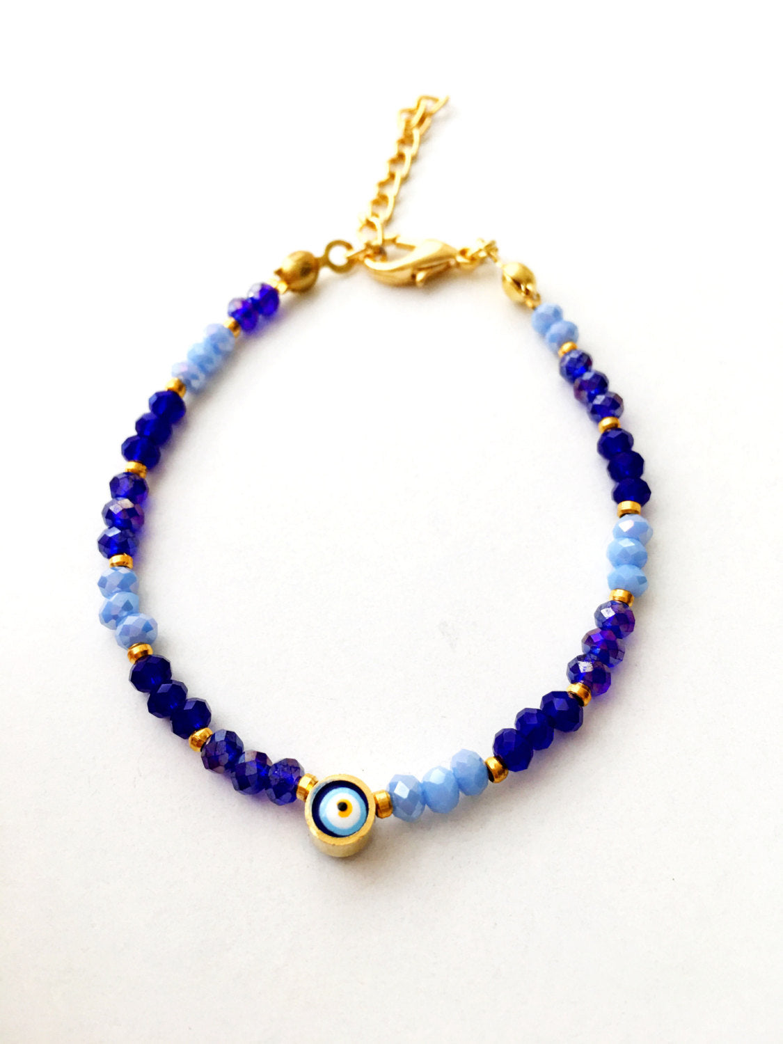 A handmade blue seed beads evil eye bracelet featuring Miyuki beads, symbolizing luck and protection, suitable for unisex wear.