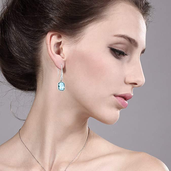 Elegant Blue Topaz Diamond Cut Drop Earrings in 18K White Gold Plated, showcasing their stunning design and craftsmanship.