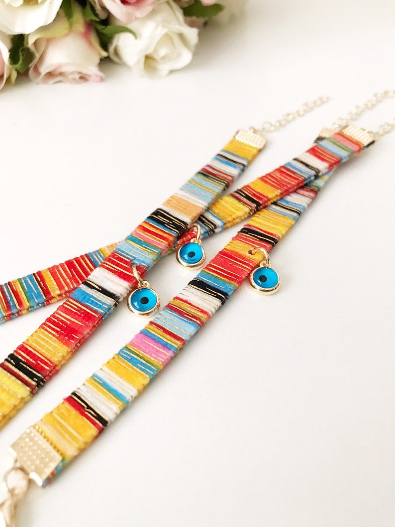 A beautifully handcrafted Bohemian Evil Eye Bracelet featuring a central evil eye charm and a braided design, perfect for protection and style.