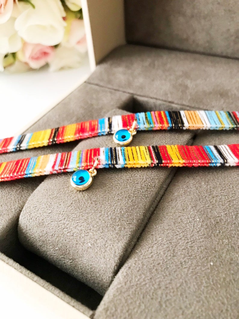 A beautifully handcrafted Bohemian Evil Eye Bracelet featuring a central evil eye charm and a braided design, perfect for protection and style.