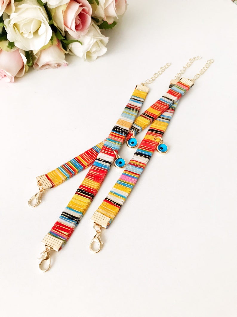 A beautifully handcrafted Bohemian Evil Eye Bracelet featuring a central evil eye charm and a braided design, perfect for protection and style.