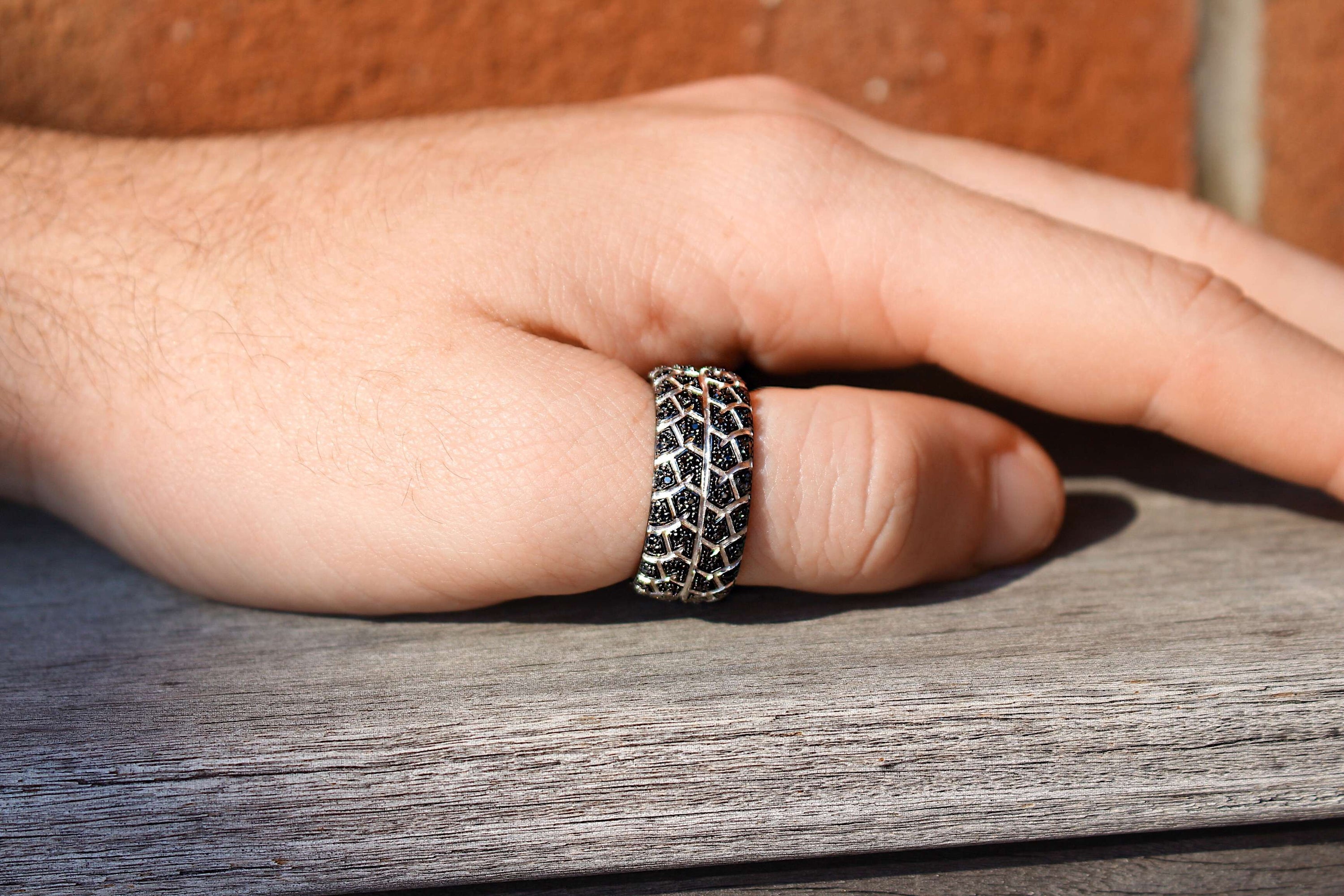 Born Drifter Black Rhodium Plated Sterling Silver Ring featuring a tire tread design and black diamonds, elegantly crafted for a modern look.