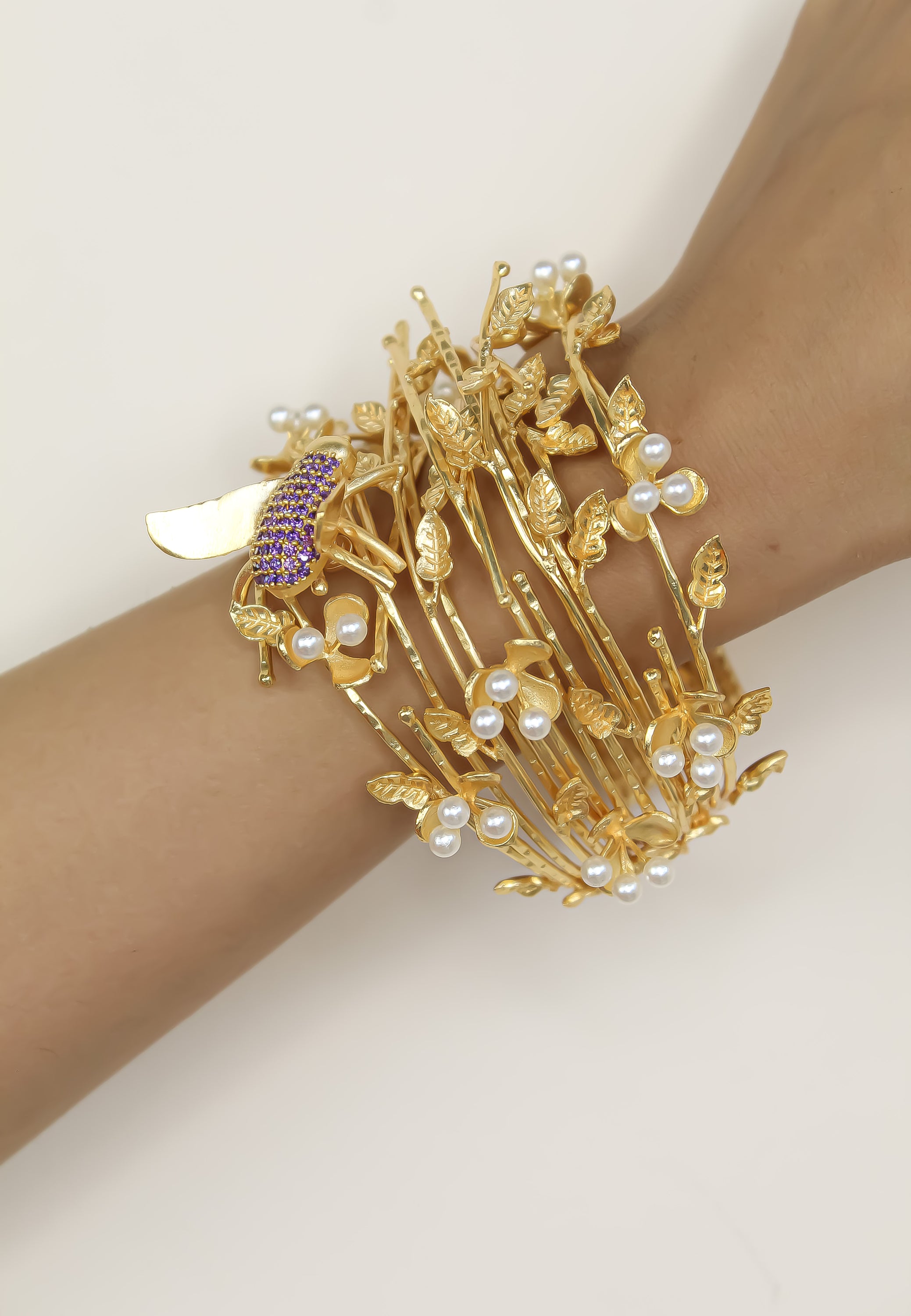 A beautifully crafted Botanical Bracelet featuring intricate floral designs, 18K gold plating, and an adjustable size for comfort.