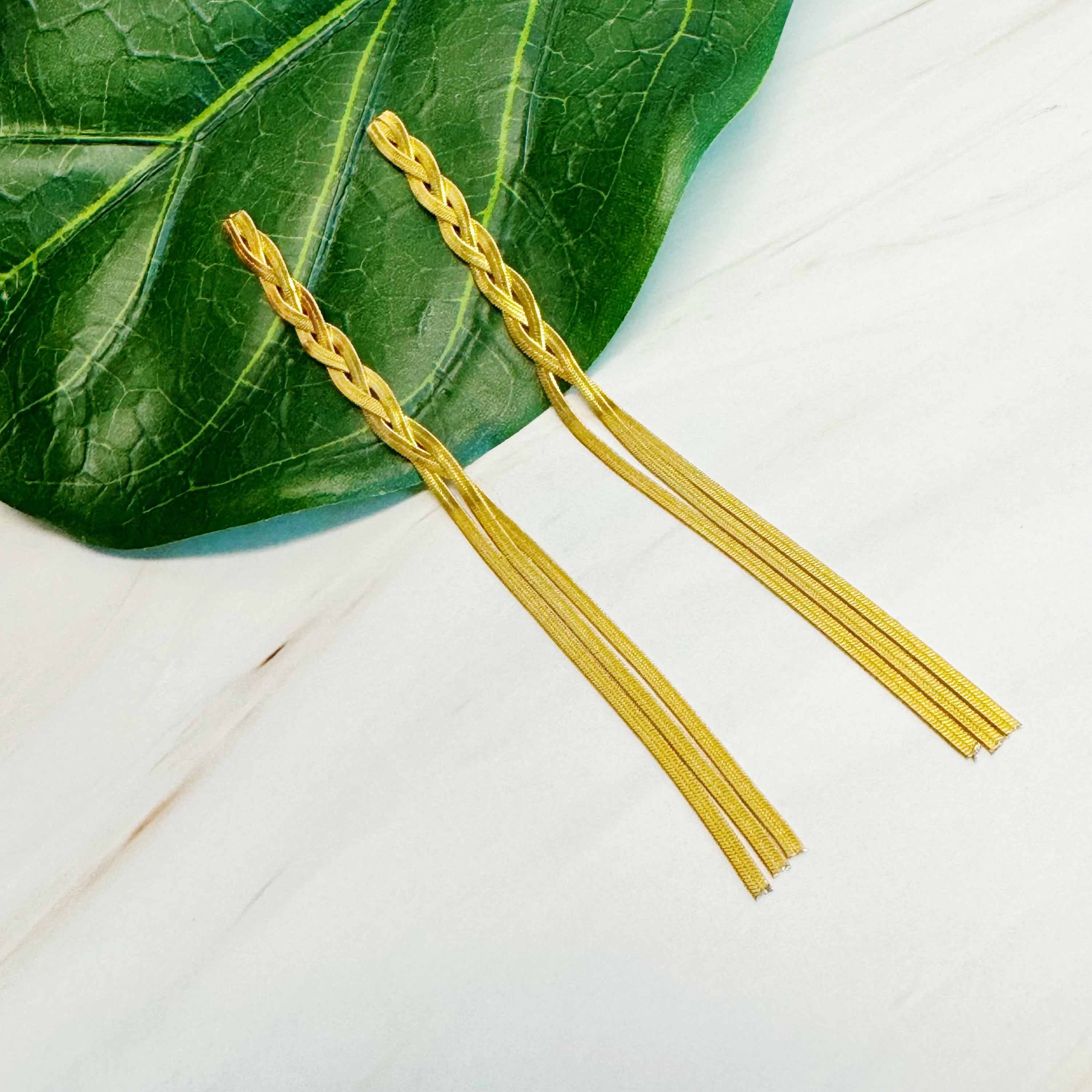 Elegant Braided Herringbone Chain Drop Earrings in 18k gold plating, showcasing a unique braided design and drop style.
