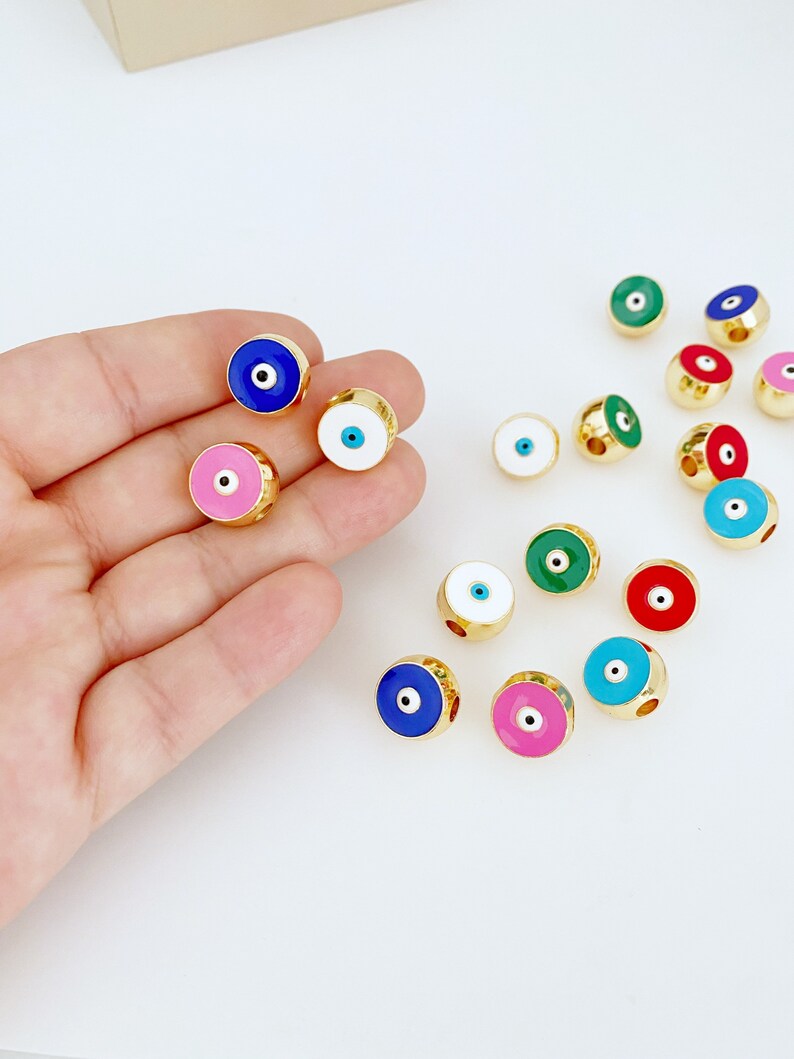 Brass Evil Eye Bead DIY in pink, red, and white colors, perfect for jewelry making.