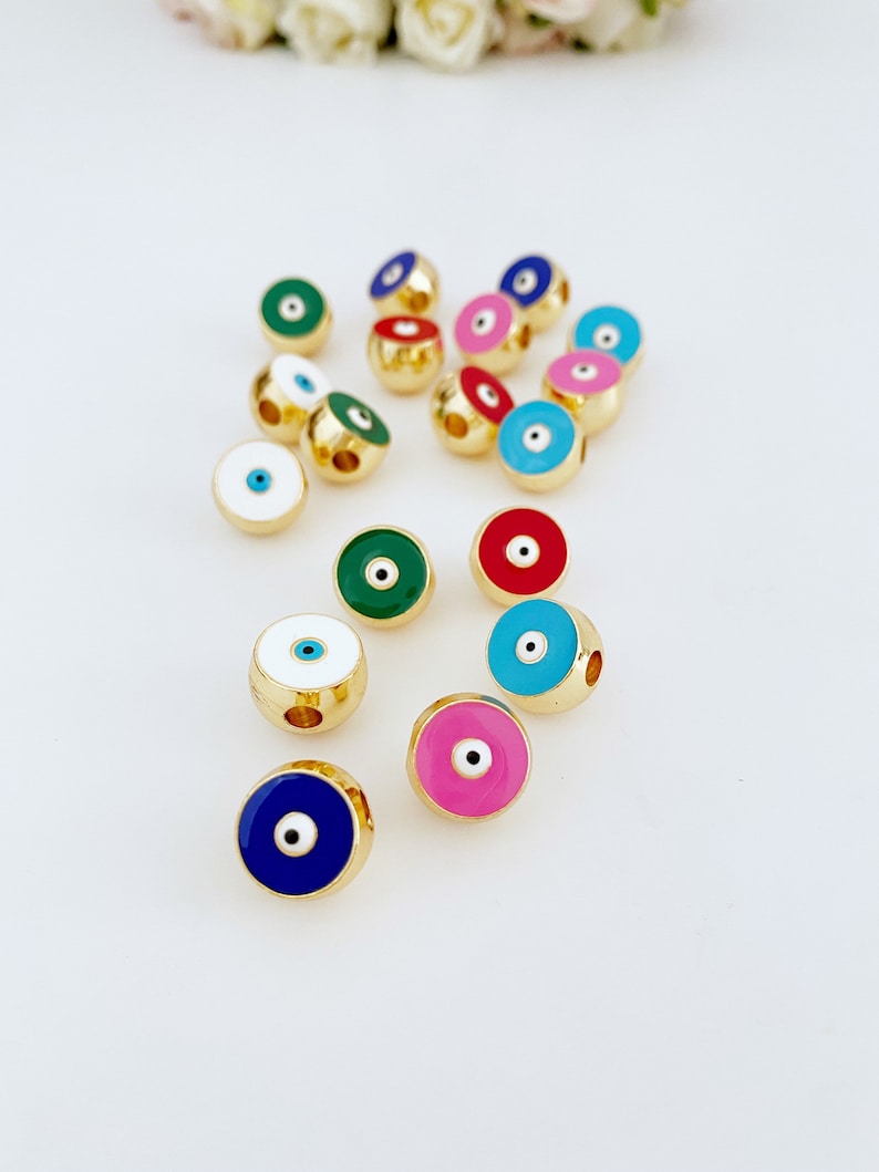Brass Evil Eye Bead DIY in pink, red, and white colors, perfect for jewelry making.
