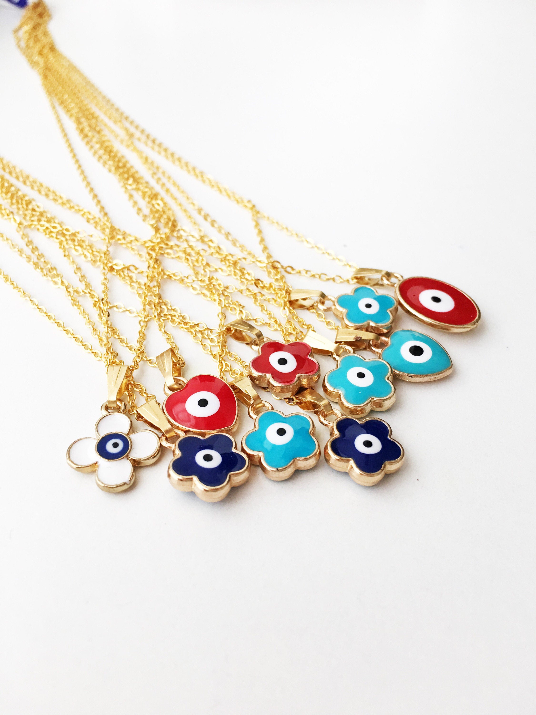 Handmade Brass Evil Eye Necklace featuring a Clover Charm on a gold chain, showcasing various color options.