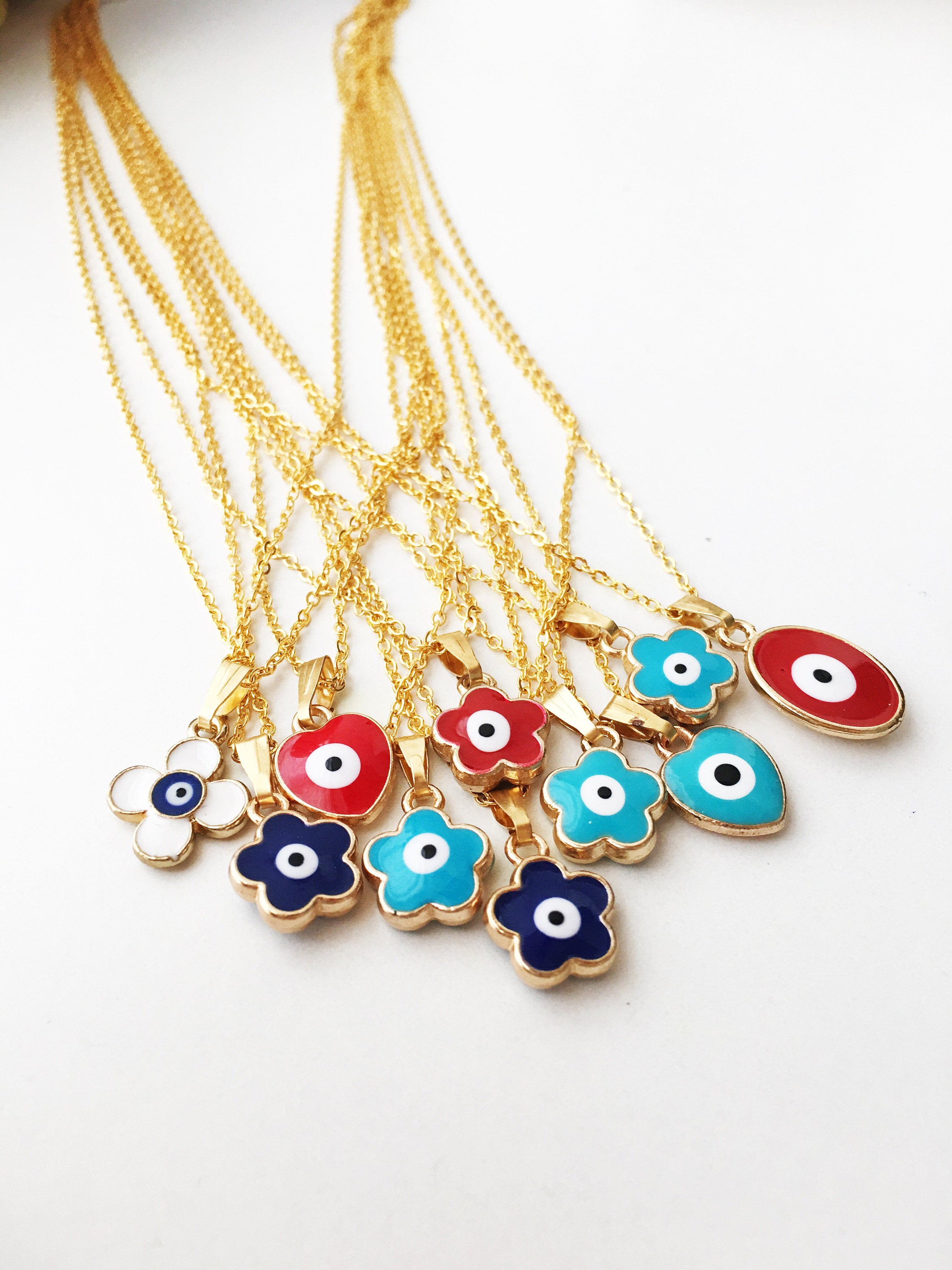 Handmade Brass Evil Eye Necklace featuring a Clover Charm on a gold chain, showcasing various color options.