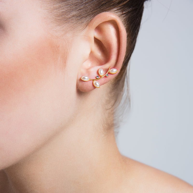 Handmade brass ear cuffs and climber earrings with 18K gold plating and clear CZ crystals, showcasing a modern and elegant design.