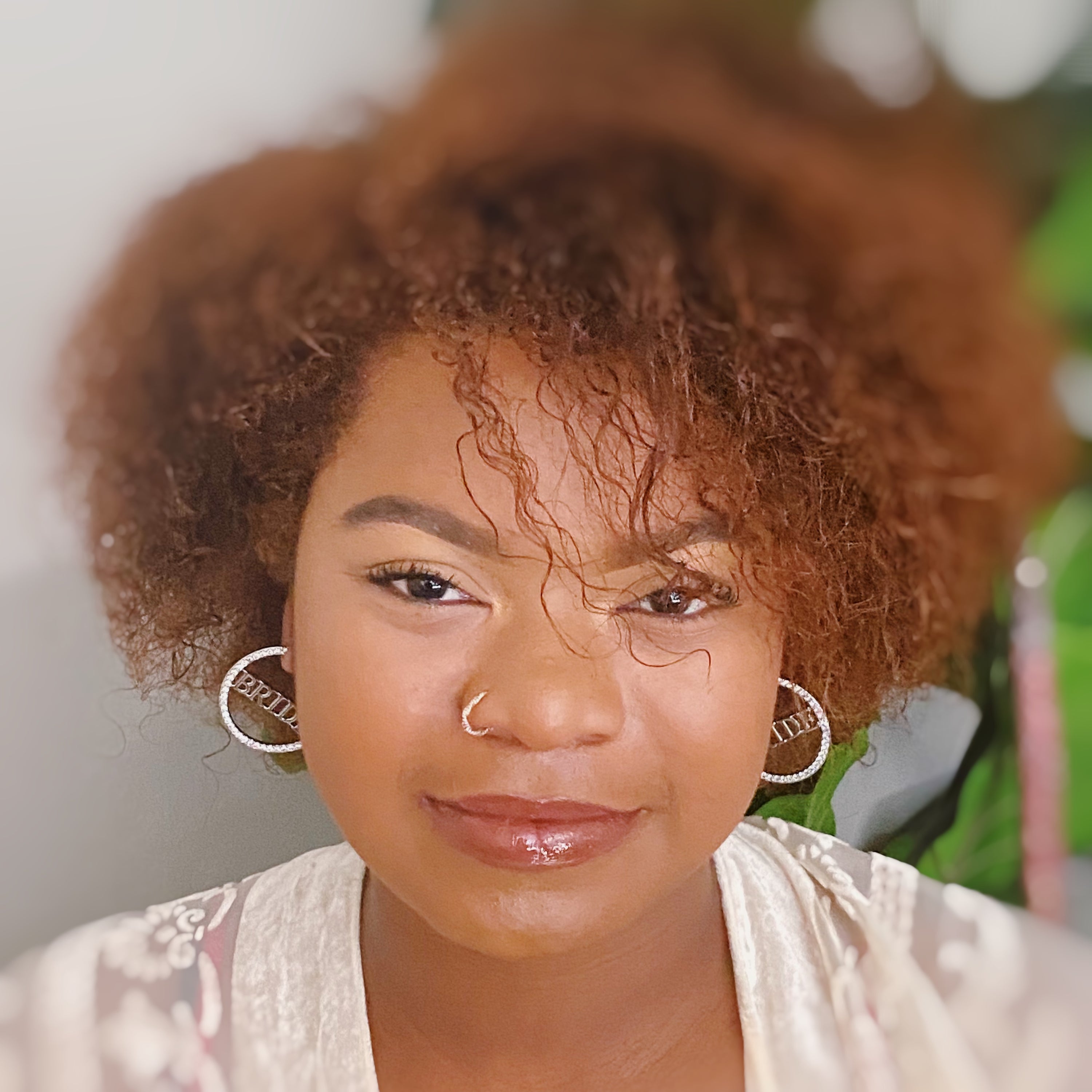 Elegant silver hoop earrings with 'BRIDE' engraving and sparkling accents, perfect for brides.