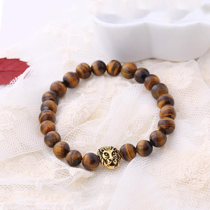 Brown natural stone lion head stretch bracelet with 18K gold plating, showcasing intricate details and a comfortable fit.