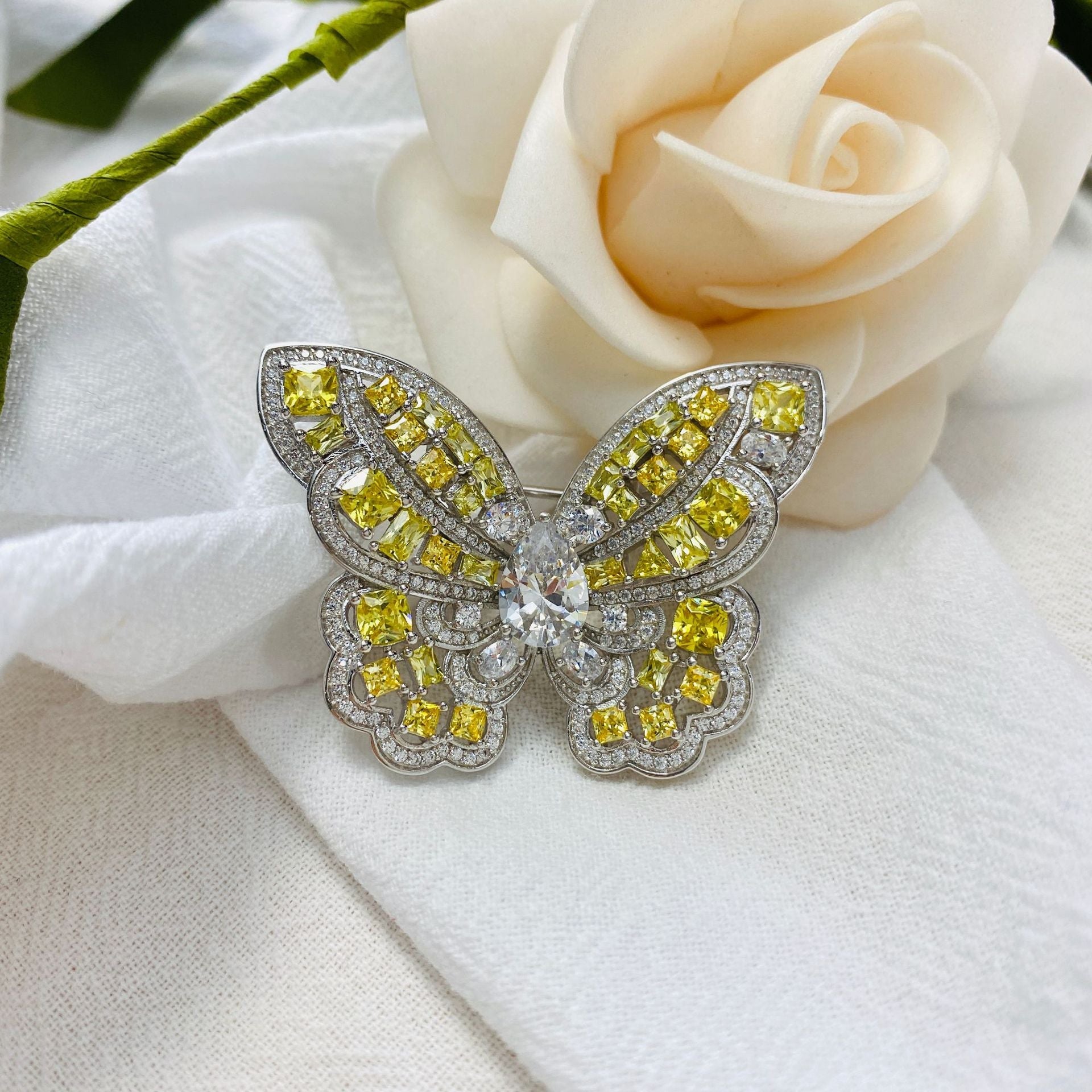Elegant Butterfly Brooch made of 925 sterling silver with yellow citrine and white cubic zirconia, showcasing intricate craftsmanship.