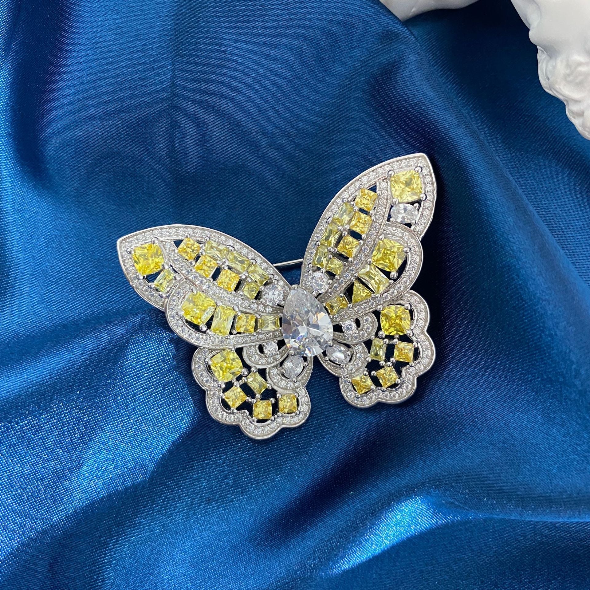 Elegant Butterfly Brooch made of 925 sterling silver with yellow citrine and white cubic zirconia, showcasing intricate craftsmanship.