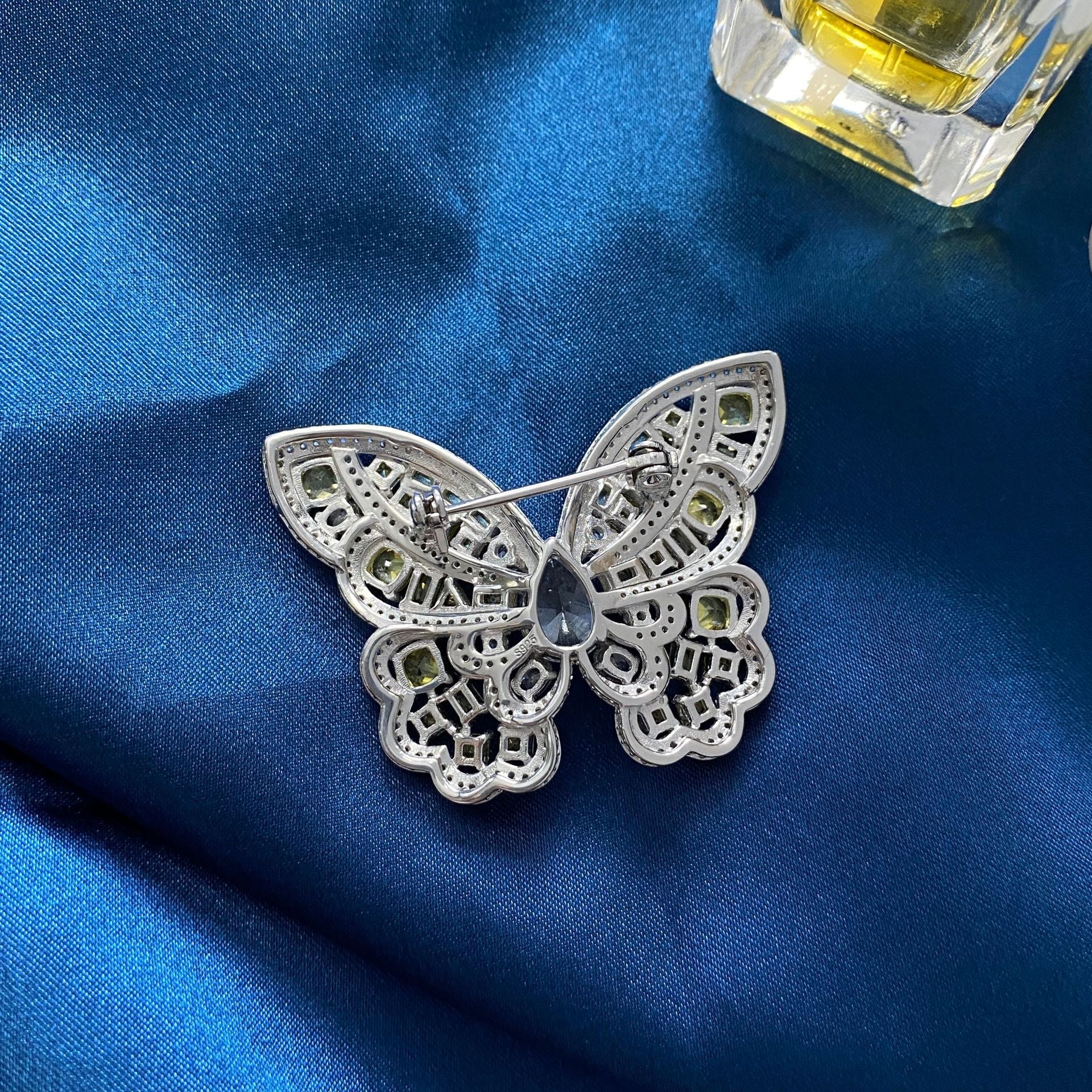 Elegant Butterfly Brooch made of 925 sterling silver with yellow citrine and white cubic zirconia, showcasing intricate craftsmanship.