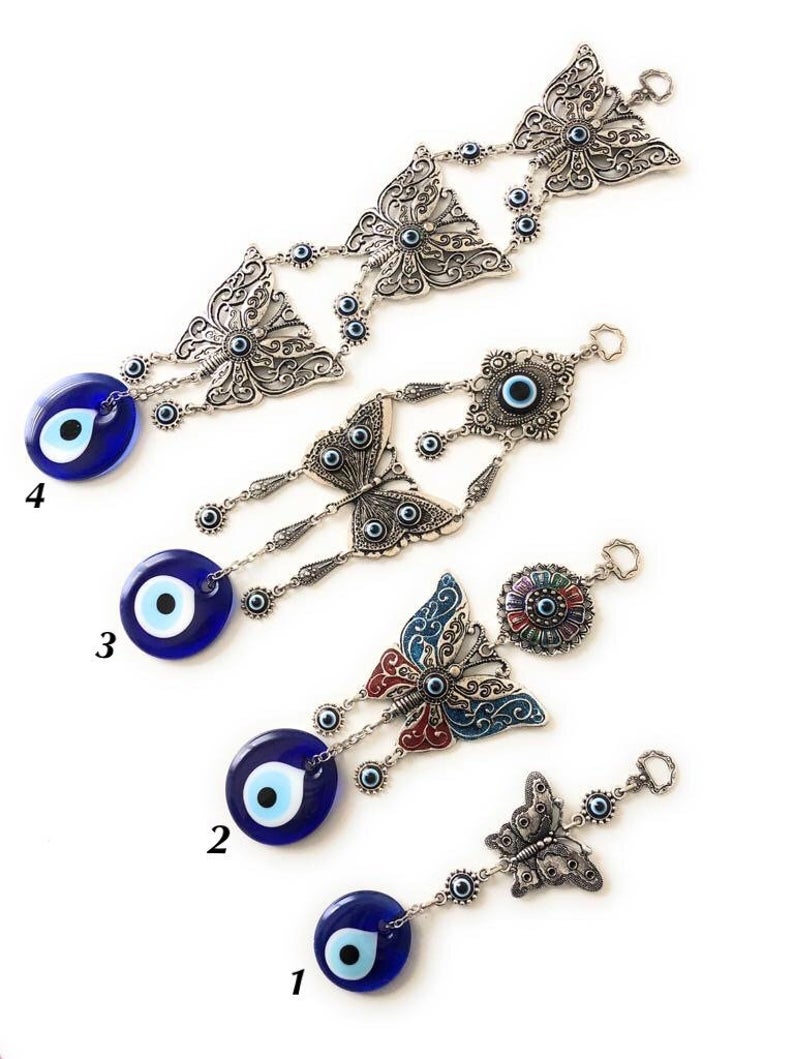 Handmade butterfly wall hanging featuring blue evil eye beads, showcasing intricate designs and vibrant colors for home decor.