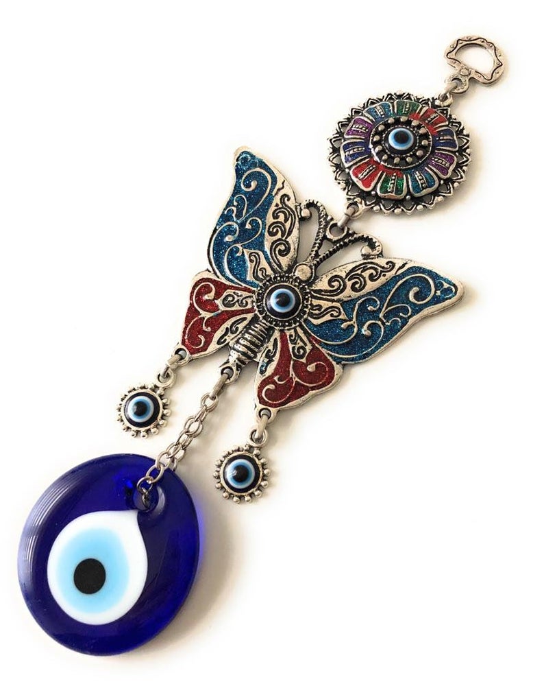Handmade butterfly wall hanging featuring blue evil eye beads, showcasing intricate designs and vibrant colors for home decor.