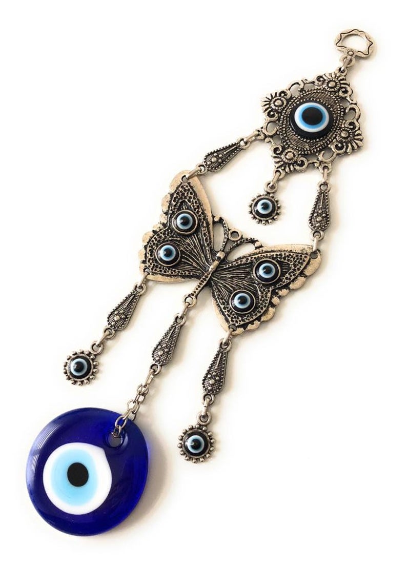 Handmade butterfly wall hanging featuring blue evil eye beads, showcasing intricate designs and vibrant colors for home decor.