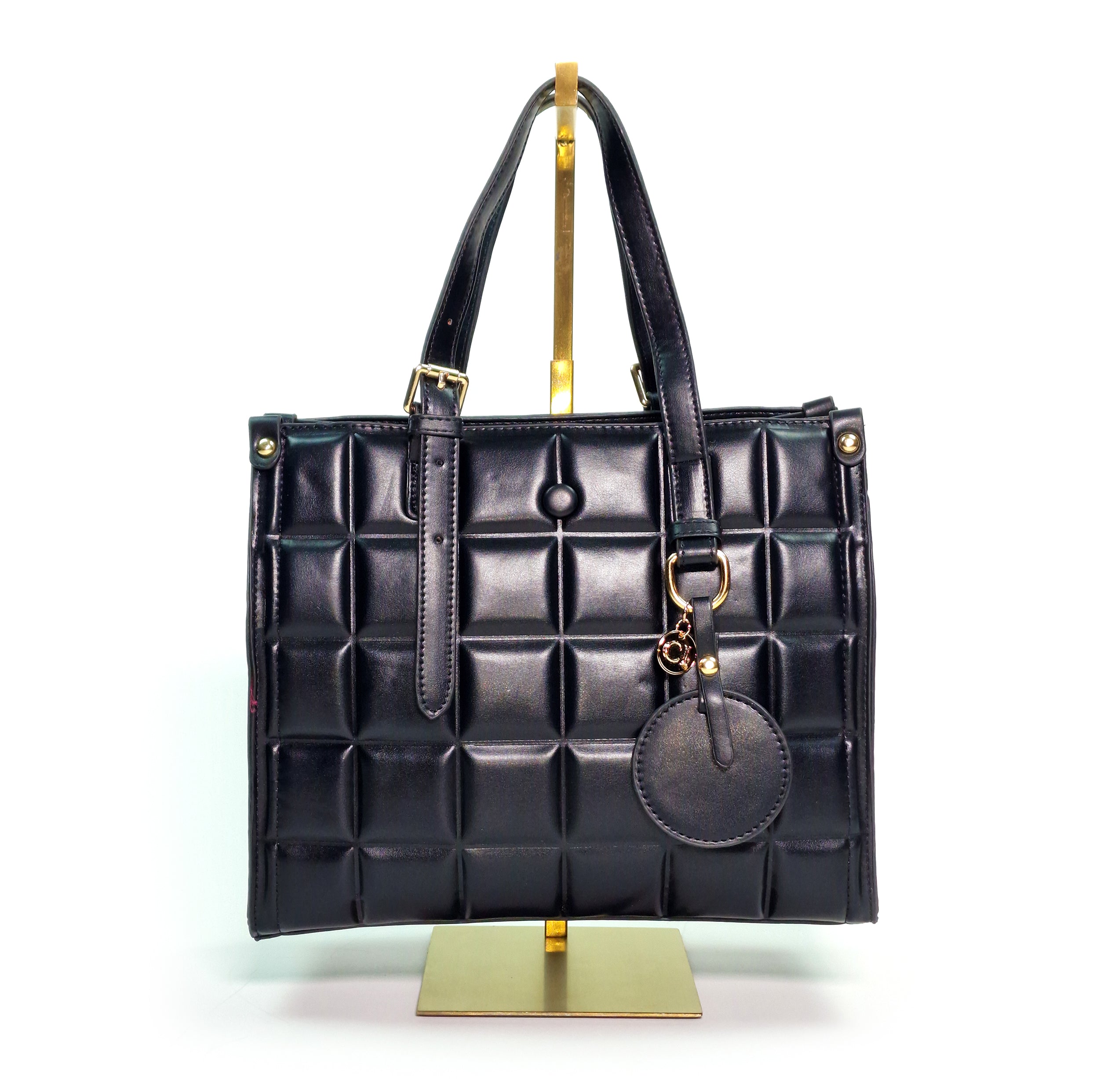 Carl Imro Burbuja Funesto handbag in black and mint green with alligator pattern and decorative elements.