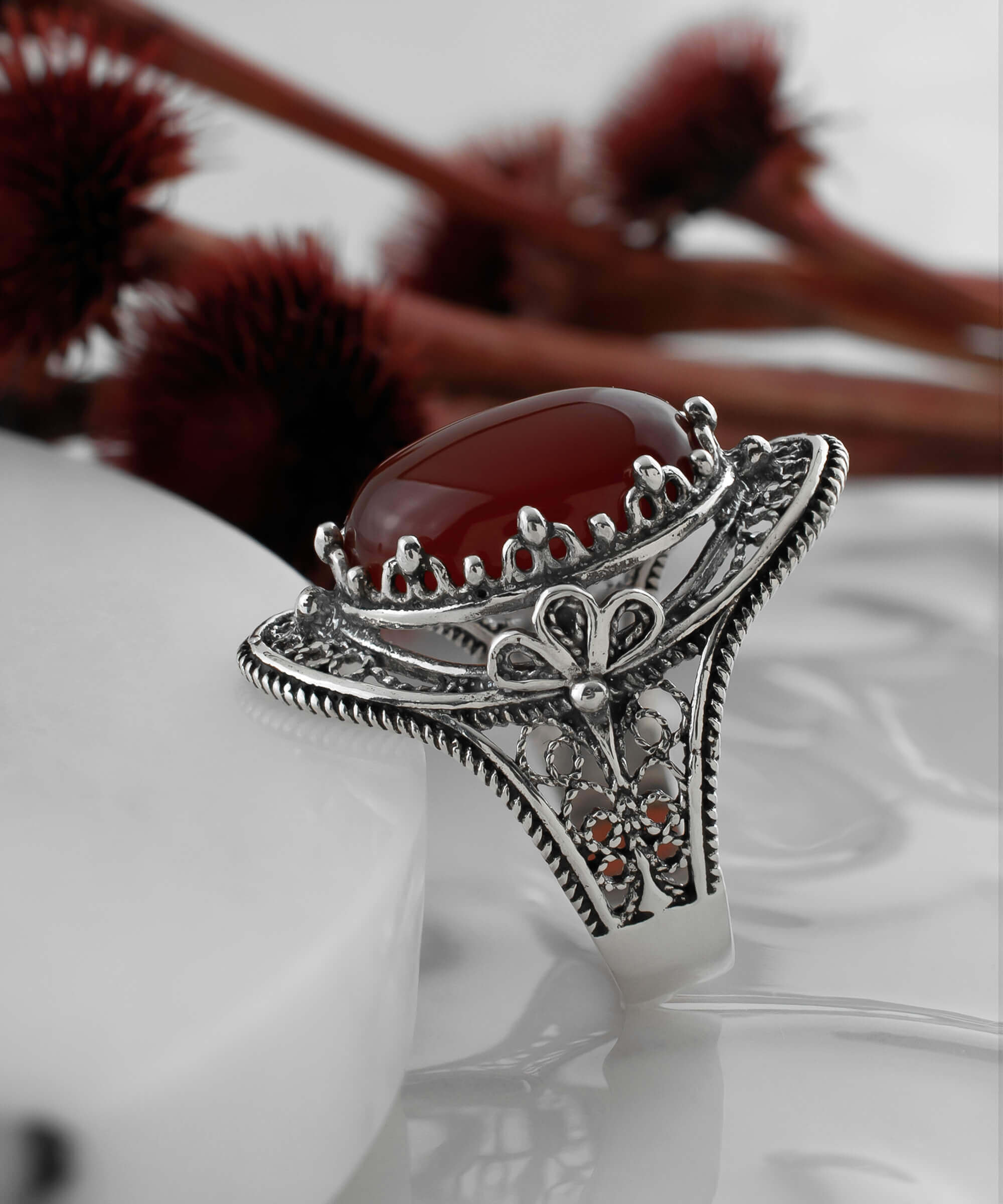 Carnelian Gemstone Filigree Art Woman Silver Statement Ring featuring an oval cut carnelian and intricate daisy filigree design.