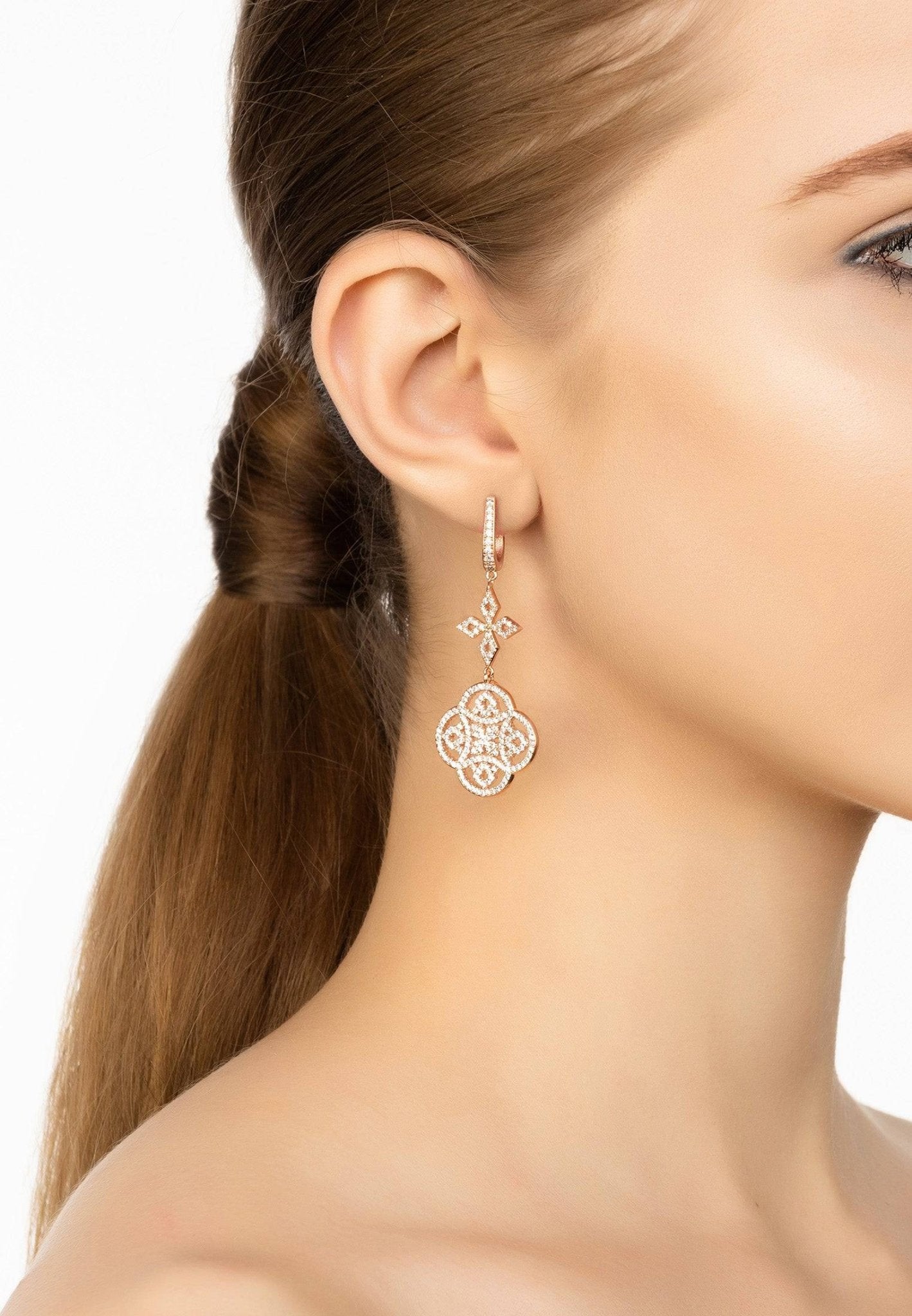 Elegant Celtic Knot Clover Drop Earrings in rosegold with intricate designs and sparkling cubic zirconia.