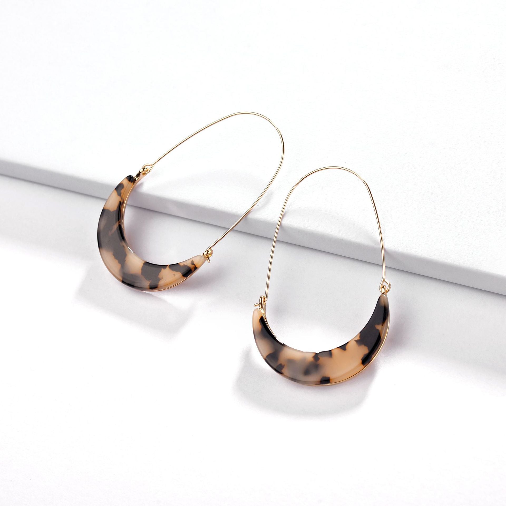 Colorful celluloid hoop earrings by DOBBI, showcasing a variety of vibrant colors and a lightweight design, perfect for summer wear.