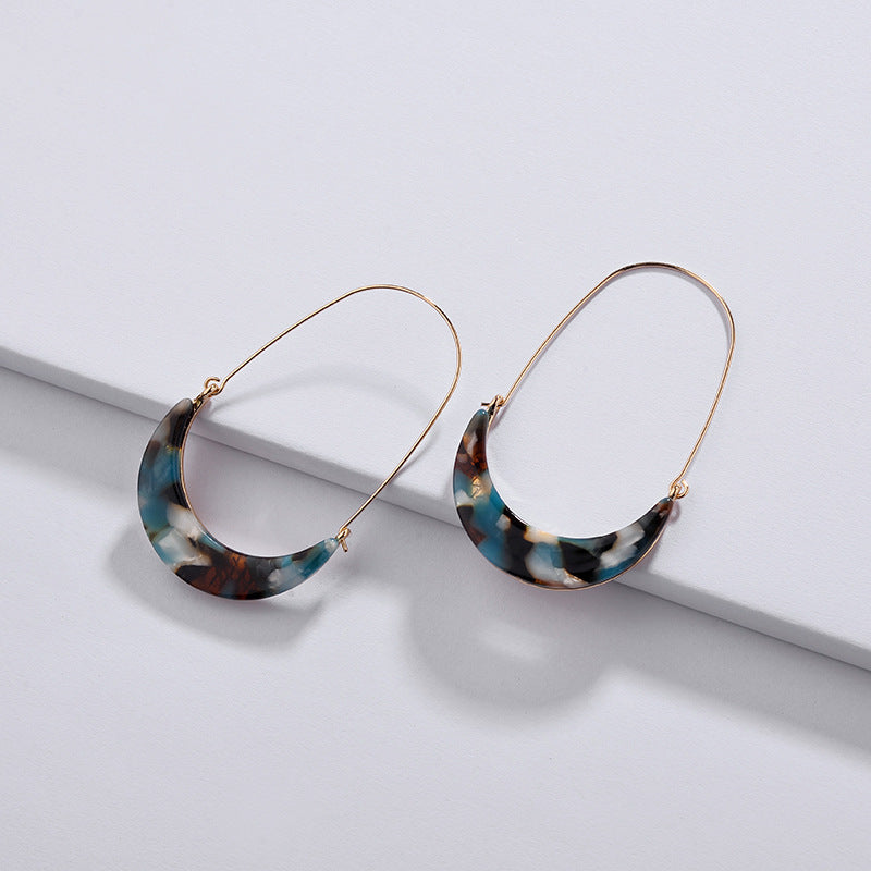 Colorful celluloid hoop earrings by DOBBI, showcasing a variety of vibrant colors and a lightweight design, perfect for summer wear.