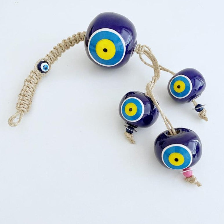 Elegant Ceramic Ball Wall Hanging featuring Turkish evil eye design, handmade with vibrant colors and unique craftsmanship.