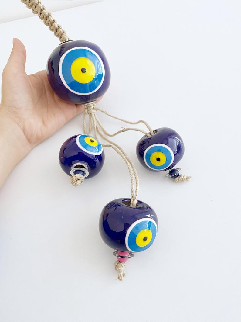 Elegant Ceramic Ball Wall Hanging featuring Turkish evil eye design, handmade with vibrant colors and unique craftsmanship.