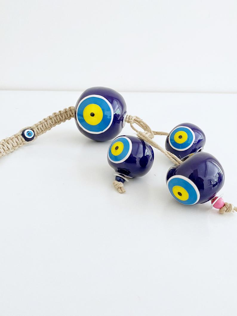Elegant Ceramic Ball Wall Hanging featuring Turkish evil eye design, handmade with vibrant colors and unique craftsmanship.