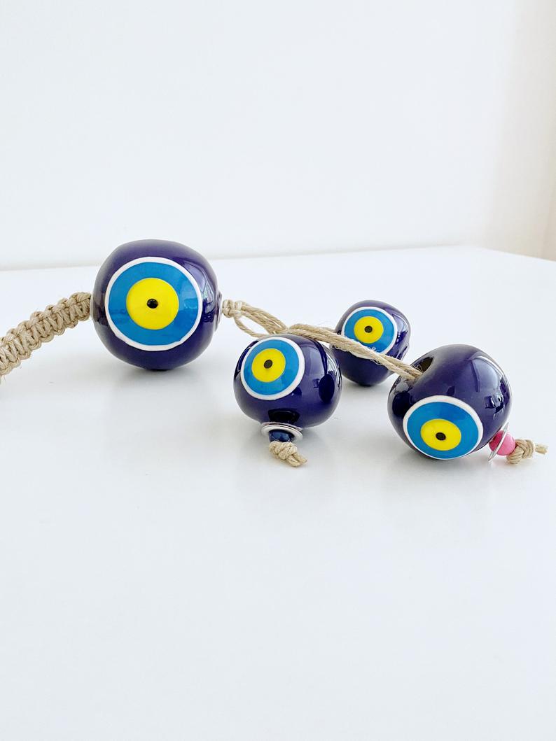 Elegant Ceramic Ball Wall Hanging featuring Turkish evil eye design, handmade with vibrant colors and unique craftsmanship.