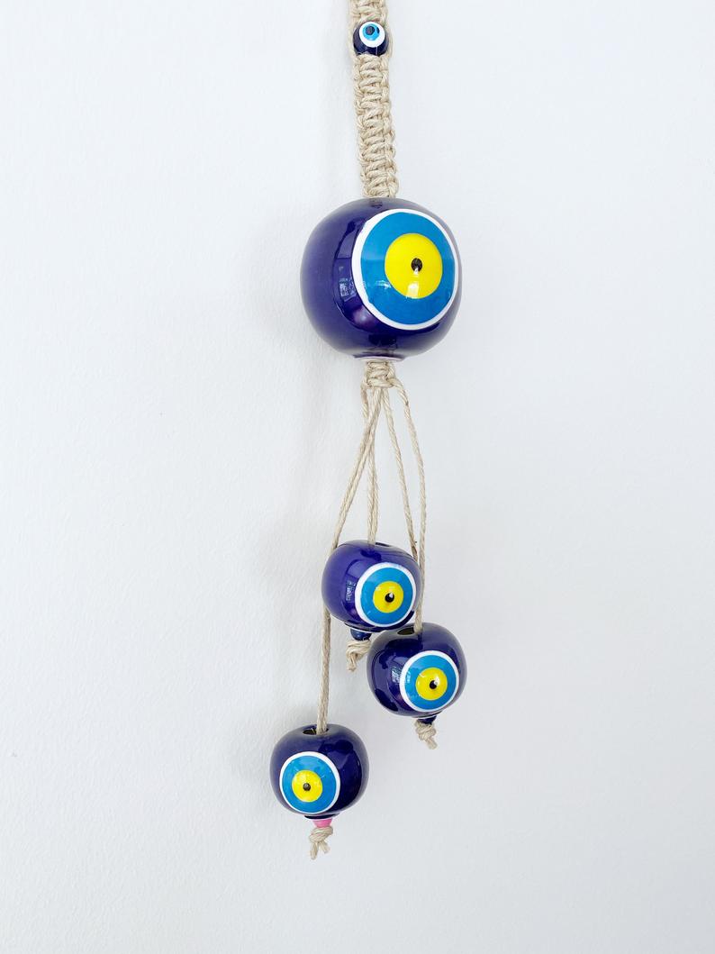 Elegant Ceramic Ball Wall Hanging featuring Turkish evil eye design, handmade with vibrant colors and unique craftsmanship.